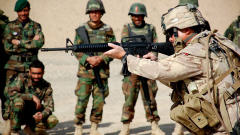 Un officier canadien montre à des soldats afghans comment manier un fusil d'assaut.