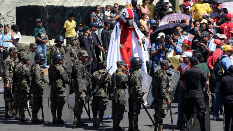 Des partisans du pr�sident d�chu d�filent devant des soldats honduriens pour le jour d'ind�pendance.