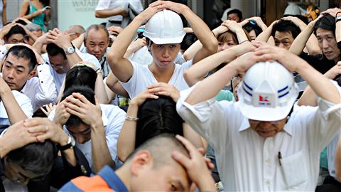 Des Japonais participent à une simulation de séisme le 27 août 2010 à Tokyo.
