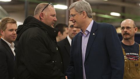 Stephen Harper serre la main de travailleurs � Dieppe, au Nouveau-Brunswick, le 1er avril 2011.