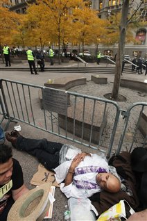 Un indigné du mouvement Occupons Wall Street à New York se repose à l'extérieur du parc Zuccotti après avoir été expulsé par les policiers le 15 novembre.