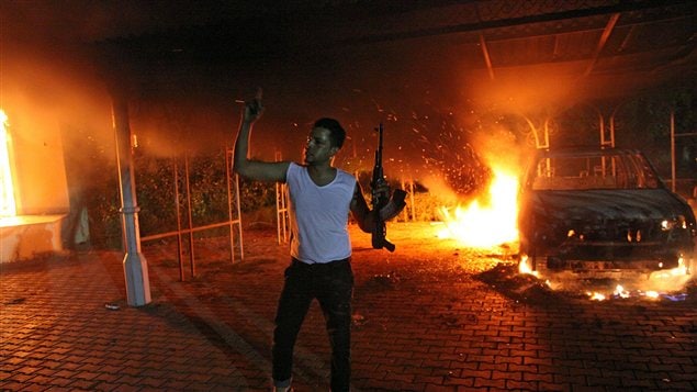 Un homme armé montre son arme alors que le consulat américain brûle à Benghazi, le 11 septembre 2012.