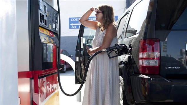 Une femme fait le plein d'essence.