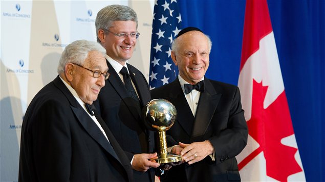 Le premier ministre canadien Stephen Harper reçoit le prix d'« Homme d'État de l'année » des mains de Henry Kissinger et du rabin Arthur Schneier, président de la fondation Appeal of Conscience, à New York.