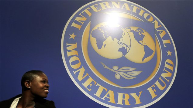 Une femme près du logo du FMi