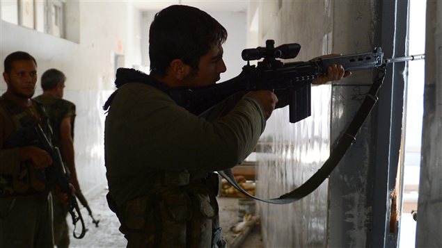 Un rebelle riposte aux soldats de Bachar Al-Assad à Alep en Syrie.