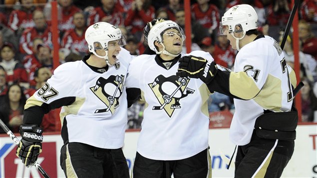 Chris Kunitz (au centre) célèbre avec Sidney Crosby et Evgeni Malkin.