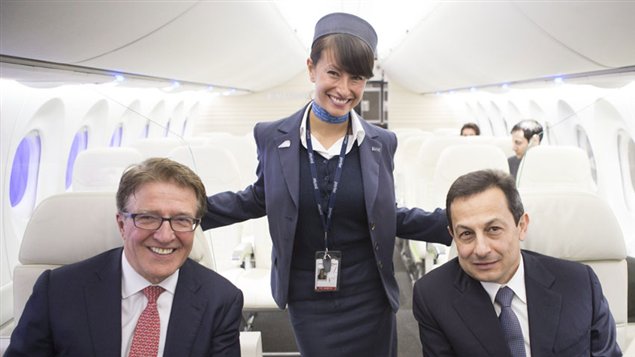 Bob Deluce, president and CEO of Porter Airlines, sits with Bombardier president Mike Arcamone inside a Bombardier CS100 model after Deluce announced the airline's purchase of 12 of the planes.