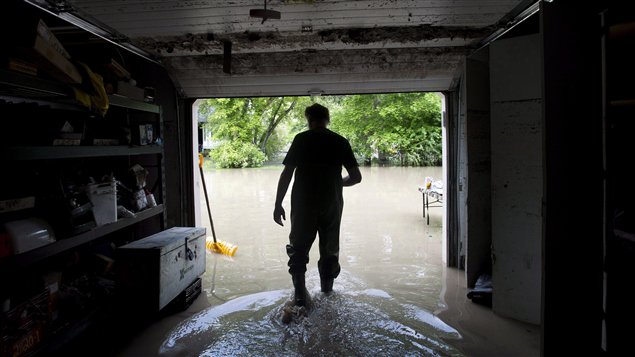 Robert Watts walked out of his garage with hip waiters on as they tried to pump the water out yesterday.