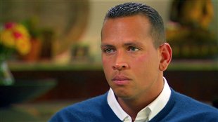 A glum Alex Rodriquez, dressed in white shirt and blue sweater answers questions in ESPN interview.