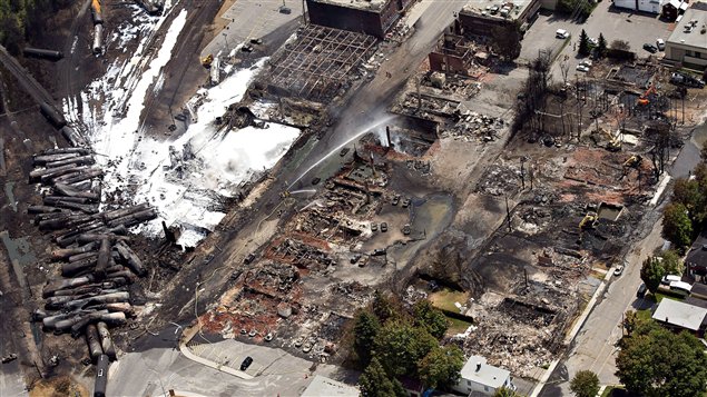 An aerial view of Lac Megantic on July 7, the day after the oil train derailment, showing water being sprayed on the tanker cars and the devastated downtown.