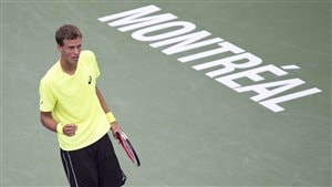 Vasek Pospisil clenches his fist as he walks off the court in yellow ti-shirt and black pants after his victory over Nikolay Davydenko on Friday.