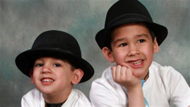 The Barthe brothers with four-year-old Noah on the left and six-year Connon on the right, are all smiles as they pose in black hats and shirts.