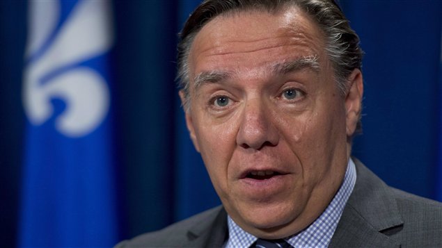Coalition Avenir Quebec Leader Francois Legault said Monday he partially supports a new charter proposed by the governing Parti Quebecois. Mr. Legault is wearing a gray suit and blue shirt with a regimental tie and is seen from the tie knot up.