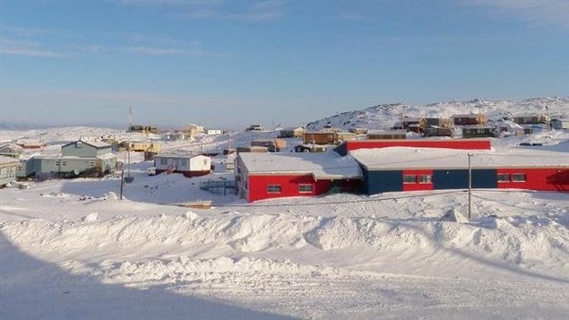 A picture of the community of Cape Dorset, Nunavut on a sunny winter day.