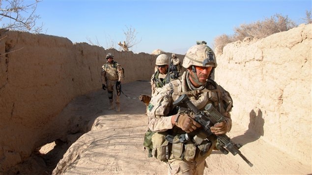 Canadian soldiers move through the village of Khenjakak in southern Afghanistan on Tuesday Jan. 4, 2011, as they search for weapons hidden by insurgents.