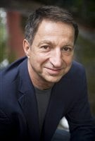 Michael Rudder in a blue sports jacket shown from the chest up.