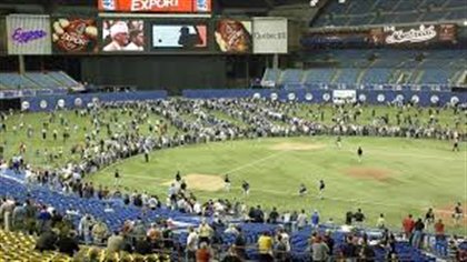 Fans fill the outfield at Olympic Stadium prior to the Expos' final game on Sept. 29, 2004, against Florida. Some fans are hoping a major league team returns to Montreal. The Blue Jays will play their final two pre-season games next spring at the