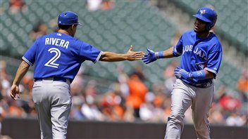 Coach Luis Rivera shakes Edwin Encarnacion's hand as the slugger rounds third after an early-season homer. Encarnacion hit 36 homers last season.