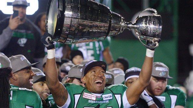  Saskatchewan Roughriders slotback Geroy Simon, flashing an enormous smile in his green uniform and surrounded by teammates, hoists the cup after beating the Hamilton Tiger-Cats 45-23 in Regina in 101st Grey Cup.  