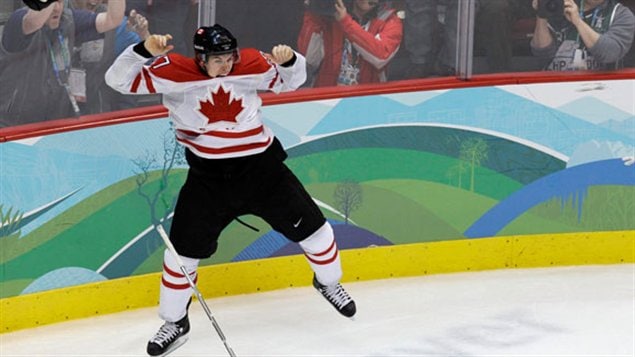 Sidney Crosby has both arms in the air in an Atlas pose after scoring the game-winning and gold-medal goal at the 2010 Vancouver Olympics. Crosby is wearing the white Canadian hockey jersey with the red maple leaf and black pants. Can he lead Canada to a repeat victory in Sochi?