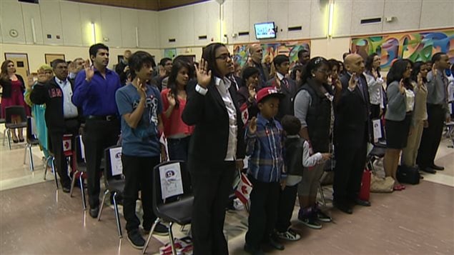 Des immigrants canadiens prêtent serment.