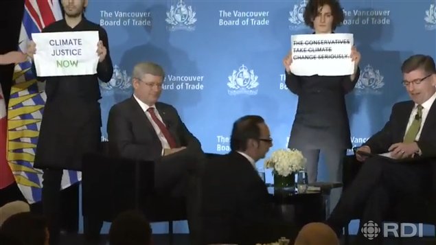 Los dos manifestantes detrás del primer ministro de Canadá.  