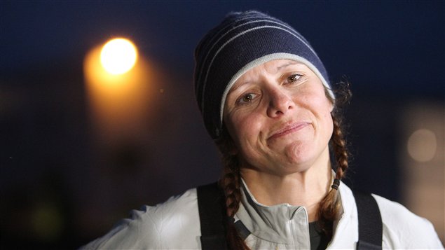 Quebec rower Mylene Paquette, her hair in pigtails under a a dark blue toque with the moon over her right shoulder, smiles to people who welcomed her as she arrives in Lorient, western France, in Novermber after her solo journey across the Atlantic Ocean. 