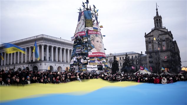 متظاهرون يرفعون العلم الأوكراني في ميدان الاستقلال