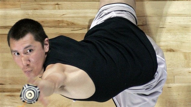 Billy Bodfish, from Wainwright, Alaska reaches for a skin ball suspended 66 inches off the floor during the one-hand reach competition at the Native Youth Olympics in Anchorage, Alaska, May 6, 2005. (AP Photo/Al Grillo, File) © AL GRILLO/AP