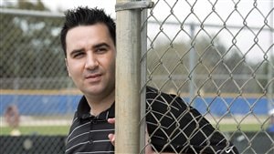 Toronto GM Alex Anthopoulos, shown in a black t-shirt beside a chain-link fence could be on the outside looking in if the Jays don't do well this season.