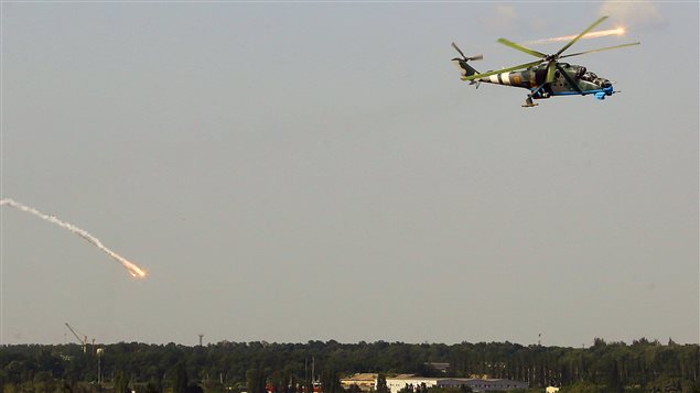 Un hélicoptère de combat ukrainien déploie des fusées leurres pour déjouer des tirs de missiles  après avoir attaqué l'aéroport de Donetsk.