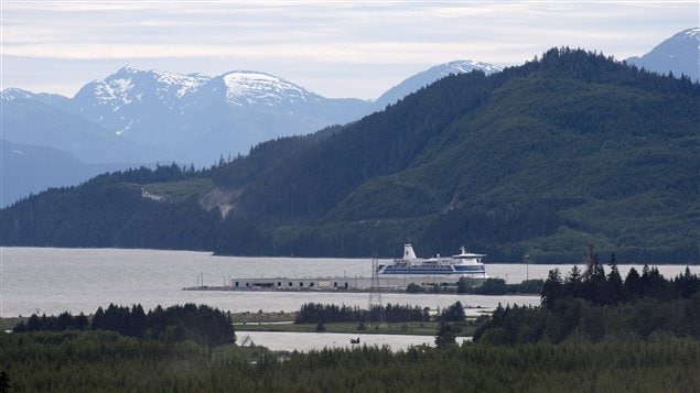A shot of a BC lake at the foot of some snowcapped mountains.