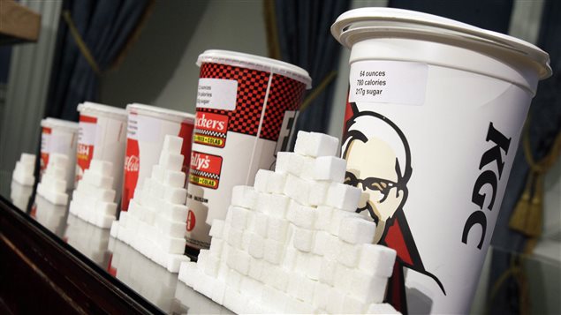 Ottawa is moving in the war on childhood obesity and chronic diesease with new regulations of the labelling of food content. The photo shows mounds of sugar cubes piled up in front of five styrofoam drinking cups.