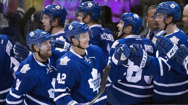 Toronto Maple Leafs Tyler Bozak (42) is congratulated on his goal along with teammate Phil Kessel (left) for the assist against the Boston Bruins during first period NHL action in Toronto in Toronto.The Leafs--at number 26--are the only NHL team on Forbes's list of the 50 most valuable franchises in sports. The boys of winter, dressed in their all-blue uniorms--are grouped along the Leafs bench and are all smiles.