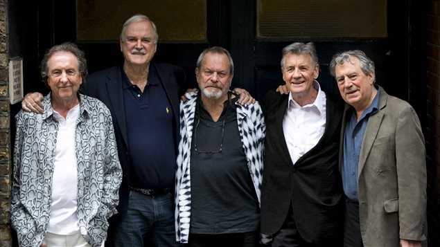 Terry Gilliam, third from left, poses with fellow members of Monty Python prior to their reunion run in London this month. The group played its final show ever on Sunday, it was seen in cinemas around the world. Gilliam's latest film will be shown in Canada after initial reports said it would not. The photo shows from left to right, Eric Idle, wearing a blue patterned long-sleeved shirt over a white tennis shirt. He has a slightly bewildered look on his face. To Idle's left in the very tall John Cleese, who has an arm on Idle's right shoulder and on the Gilliam's left shoulder. Cleese is wearing a dark blue sports jacked at dark blue polo shirt and jeans to match. He, too, looks slightly bewildered. Gilliam, is wearing a gray polo shirt with a white and black scarf draped over his shoulders. His hair is close cropped and he is sporting a beard. To Gilliam's left is Michael Palin, who is wearing a dark sports jacket over a white dress shirt. The jacket remains buttoned and he looks slightly dishevelled but does have a smile on his face. On the far right is Terry Jones. He is wearing a light gray suede jacket over a blue shirt and dark pants. He, too, looks slightly bewildered. All of the men have something resembling pot bellies. However, when it came time to perform on Sunday, they were excellent, exhibiting something very much resembling the energy of their youth back in the late 60s and early 70s.