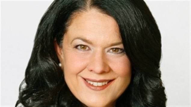 Mayor Lucie Roussel died Sunday afternoon in Stratford, Quebec., after being stung multiple times by wasps. The photo shows Ms. Roussel in closeup from the bottom of the chin up. She has long black hair parted on the right and is smiling slightly, as if slightly nervous by having her picture taken. Her hair covers her left ear. On her right ear is a small pearl-like round earring.