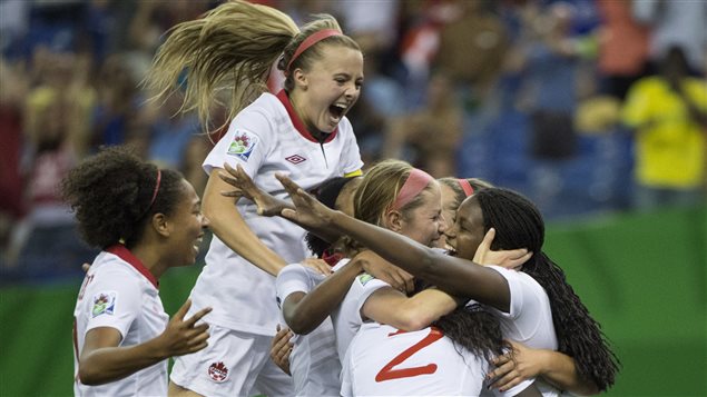 Teammates gather around Canada's Janine Beckie to celebrate her goal against North Korea during second half of FIFA U20 Women's World Cup soccer action Tuesday, in Montreal.