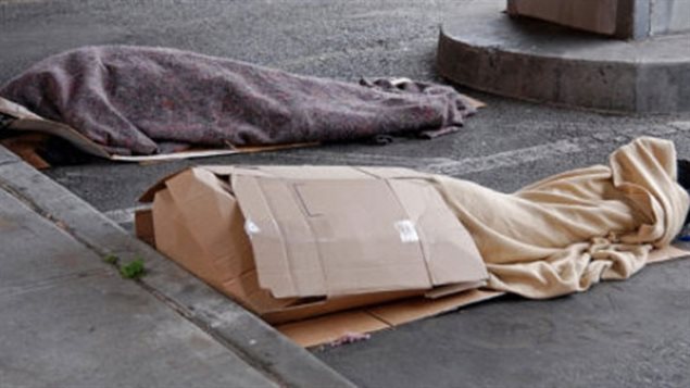 Between two-thirds and three-quarters of Quebec's homeless population live in Montreal. Now, some are finding a way to feel a little better about themselves thanks to personal trainer Sam Maniatis. We see two people sleeping side-by-side under heavy blankets.