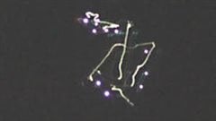 Thirteen percent of the UFO sightings over Canada in the last 25 years remain unexplained. Here we see what appear to be five brightly-lit comet tails, some of them connected, surrounded by a series of small blue lights.