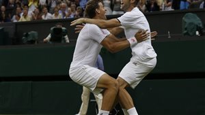 Vasek Pospisil left, and Jack Sock celebrate after winning the men's doubles final at Wimbledon in June. There were no similar celebrations in New York. We see them both in their all-white outfits (it's Wimbledon, after all). Sock has both arms on Pospisil's shoulders while Pospisil has his hands around Sock's back. They appear set to hoist each other into the air. Both have ecstatic smiles on their faces.