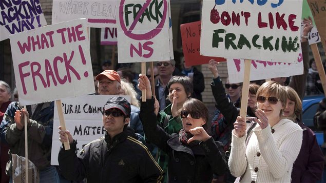 Nova Scotia says it will listen to anti-fracking activists and introduce legislation to prohibit high-volume hydraulic fracturing. We see a couple of dozen people holding signs protesting fracking. One sign says "What the FRACK!" Another says "Birds don't like fracking."
