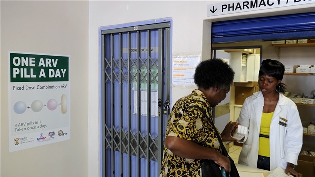 Une femme reçoit ses médicaments contre le VIH, dans une pharmacie de Phedisong, en Afrique du Sud.