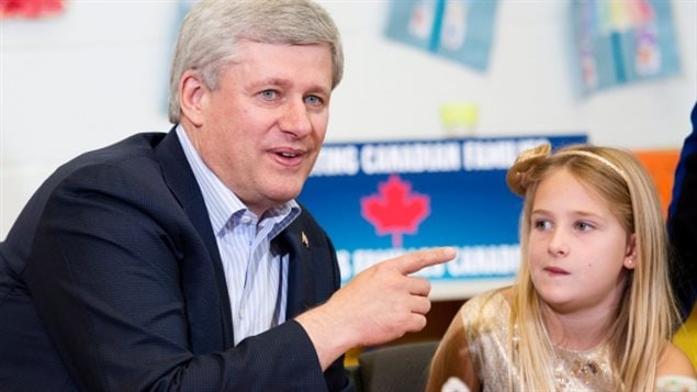 Prime Minister Stephen Harper does arts and crafts with a student at the Joseph and Wolf Lebovic Jewish Community Campus in Vaughan, Ont., on Thursday after announcing his government's income-splitting proposal. 