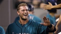 Michael Saunders, a Mariner last season, has been given the left field job in Toronto. The Jays hope he playing at Rogers Centre will increase his power numbers. Saunders is walking through the dugout slapping five, wearing the teal-based white-scripted 