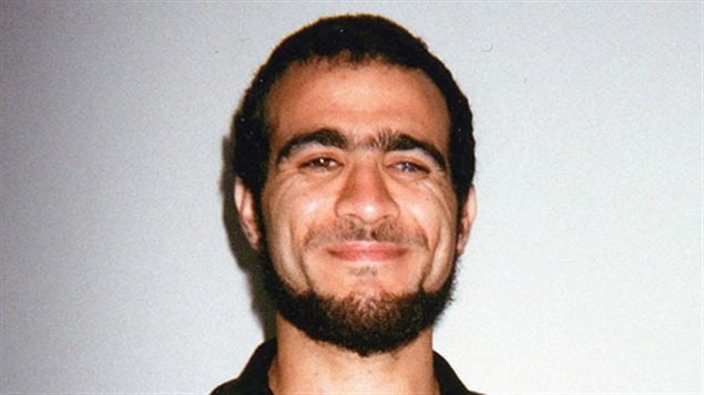Omar Khadr is shown in an undated handout photo from the Bowden Institution in Innisfail, Alberta. We see a young man from the neck up. His beard is well trimmed and both his lips and eyes are smiling. His hair is cut quite short, his eyebrows are full and he has a healthy, dark complexion