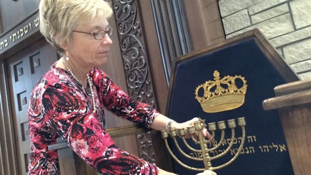 Susan Bloomfield places the menorah on display at the Ottawa Torah Centre.