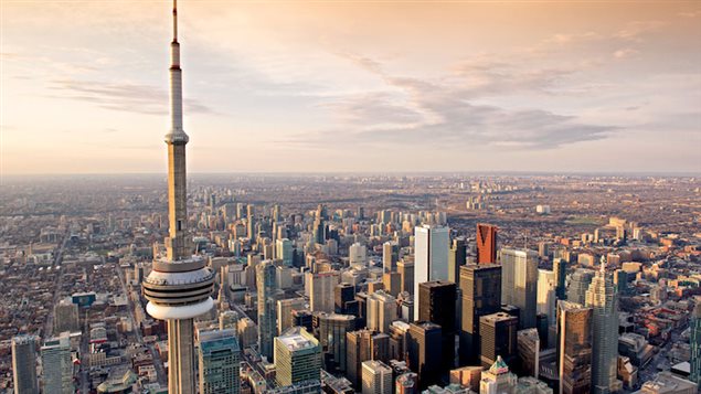 Toronto's CN Tower and the Financial District, where CEOs are seeing their compensation soar, compared to other Canadians. In this aerial shot from the west, we see the CN Tower in the foreground and the skyscrapers of the financial district bound together reaching skyward.