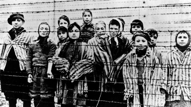 Un groupe de femmes et d'enfants sont photographiés à Auschwitz juste après la libération par l'armée soviétique en janvier 1945. (Associated Press)