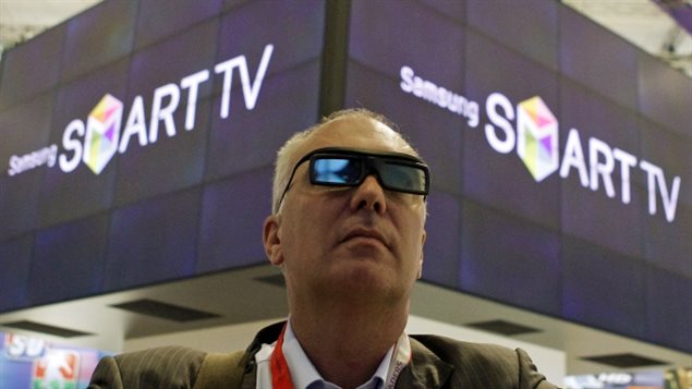 Un homme regarde une présentation de reconnaissance vocale de la SmartTV la technologie de Samsung. (Thomas Peter / Reuters)